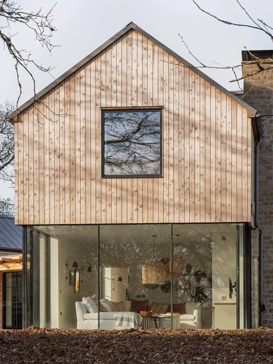 Hazelbridge Cottage sheltered terrace with timber pergola, outdoor dining, and poolside view